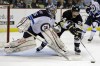 Gene J. Puskar / The Associated Press
Pittsburgh Penguins left wing Matt Cooke (24) reaches for the puck in front of Winnipeg Jets goalie Al Montoya (35) during the second period of an NHL hockey game in Pittsburgh, Thursday.