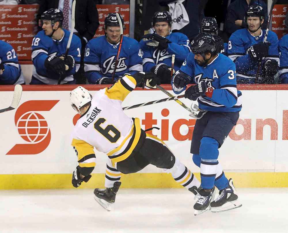THE CANADIAN PRESS/Trevor Hagan
Winnipeg Jets' Dustin Byfuglien hits Pittsburgh Penguins' Jamie Oleksiak during first period in Winnipeg, Tuesday.