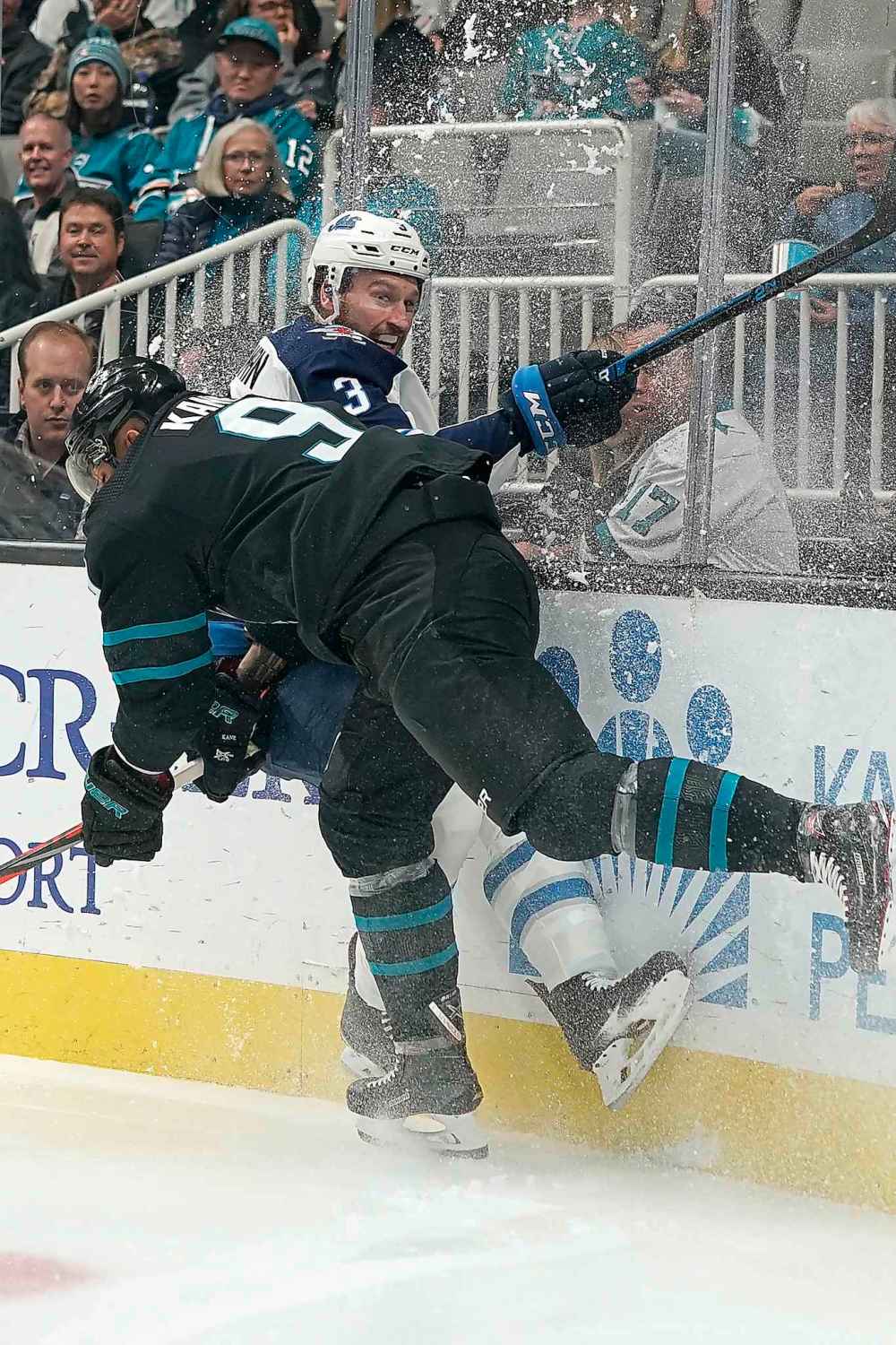 (AP Photo/Tony Avelar)
Winnipeg Jets defenceman Tucker Poolman is checked by San Jose Sharks left wing Evander Kane during the first period.