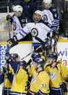 Mark Humphrey / The Associated Press Files
Dustin Byfuglien looks on as the Nashville Predators celebrate an overtime win Oct. 24 in Nashville. Care to guess which player turned over the puck to set up the game-winning goal?