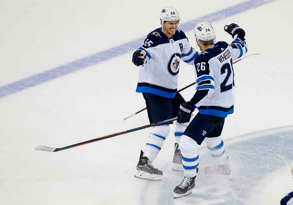 Winnipeg Jets centre Mark Scheifele (left) celebrates with captain Blake Wheeler after scoring the winning goal in the shootout Sunday.
NOAH MURRAY / THE ASSOCIATED PRESS