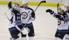 Carlos Osorio / The Associated Press
The Jets celebrate their 5-4 shootout triumph over the Detroit Red Wings.