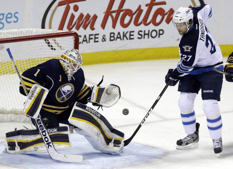 David Duprey / the associated press
Buffalo Sabres goalie Jhonas Enroth makes a save on a shot by Winnipeg Jets forward Eric Tangradi during the first period of an NHL game in Buffalo, N.Y., Monday.