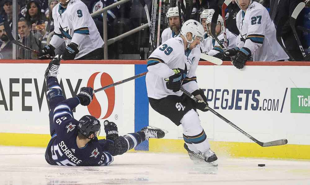THE CANADIAN PRESS/Trevor Hagan
Winnipeg Jets' Mark Scheifele and San Jose Sharks' Logan Couture battling for the puck during the second period in Winnipeg, Tuesday.