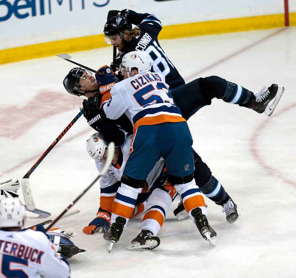 PHIL HOSSACK / WINNIPEG FREE PRESS
Winnipeg Jets' Mark Scheiflele gets tackled by the Islanders' Casey Cizikas and Adam Pelech during a scrum in front of the Islanders' net, Thursday. There was no penalty on the play.