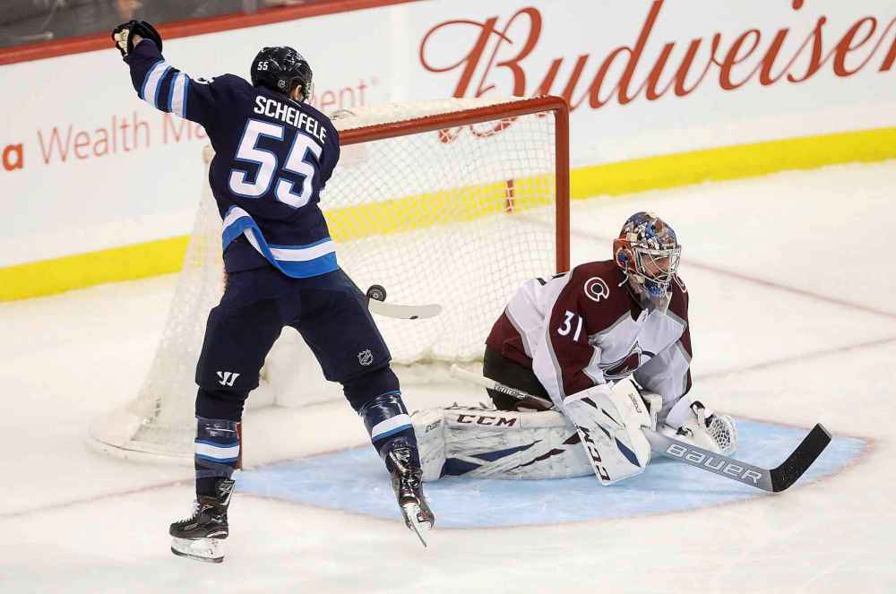 THE CANADIAN PRESS/Trevor Hagan
Winnipeg Jets' Mark Scheifele knocks his own rebound out of the air and into the back of the net behind Colorado Avalanche goaltender Philipp Grubauer during the third period Tuesday.