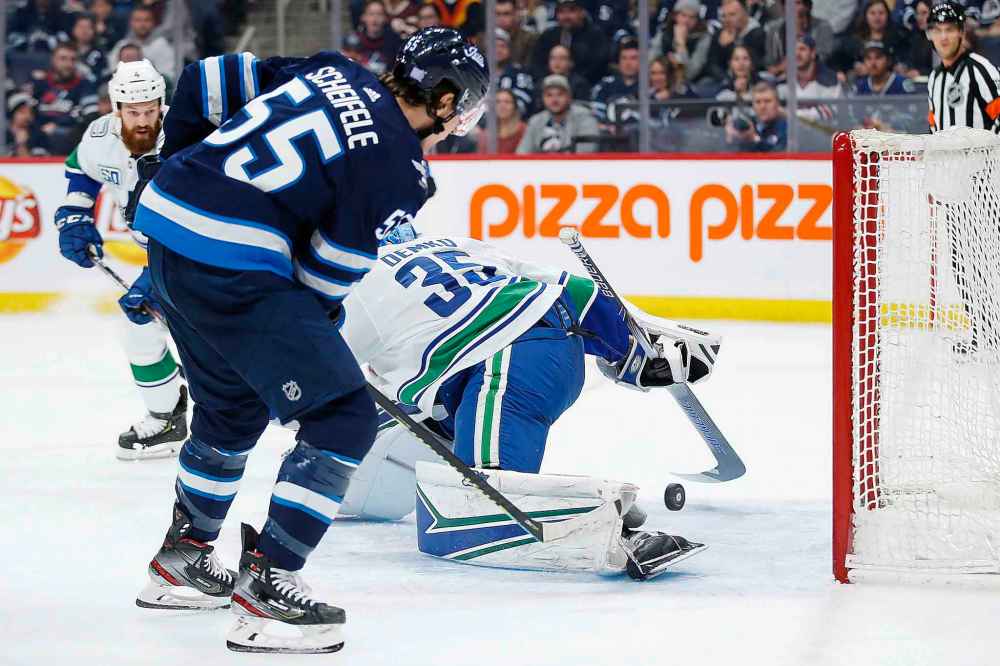 THE CANADIAN PRESS/John Woods
Winnipeg Jets' Mark Scheifele buries the puck behind Vancouver Canucks goaltender Thatcher Demko during the second period.
