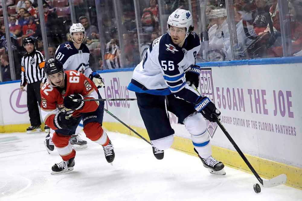(AP Photo/Lynne Sladky)
Winnipeg Jets centre Mark Scheifele rags the puck as Florida Panthers' Denis Malgin defends during the second period.