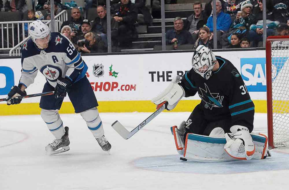 (AP Photo/Jeff Chiu)
San Jose Sharks goalie Martin Jones defends on a shot in front of Winnipeg Jets centre Mark Scheifele during the second period, Thursday.