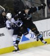Marcio Jose Sanchez / The Associated Press 
San Jose Sharks' Jason Demers (5) collides against the boards with Winnipeg Jets' Jacob Trouba during the first period Thursday night in San Jose.