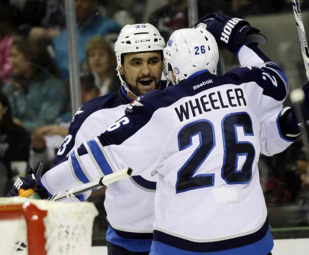 Marcio Jose Sanchez / The Associated Press
Winnipeg Jets' Dustin Byfuglien, left, celebrates his goal with teammate Blake Wheeler (26) during the second period.