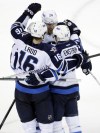 Marcio Jose Sanchez / The Associated Press
Winnipeg Jets' Tobias Enstrom, bottom right, of Sweden, is hugged by teammates after scoring the go-ahead goal against the San Jose Sharks during the third period of an NHL hockey game on Thursday, March 27, 2014, in San Jose, Calif. The Jets won 4-3.