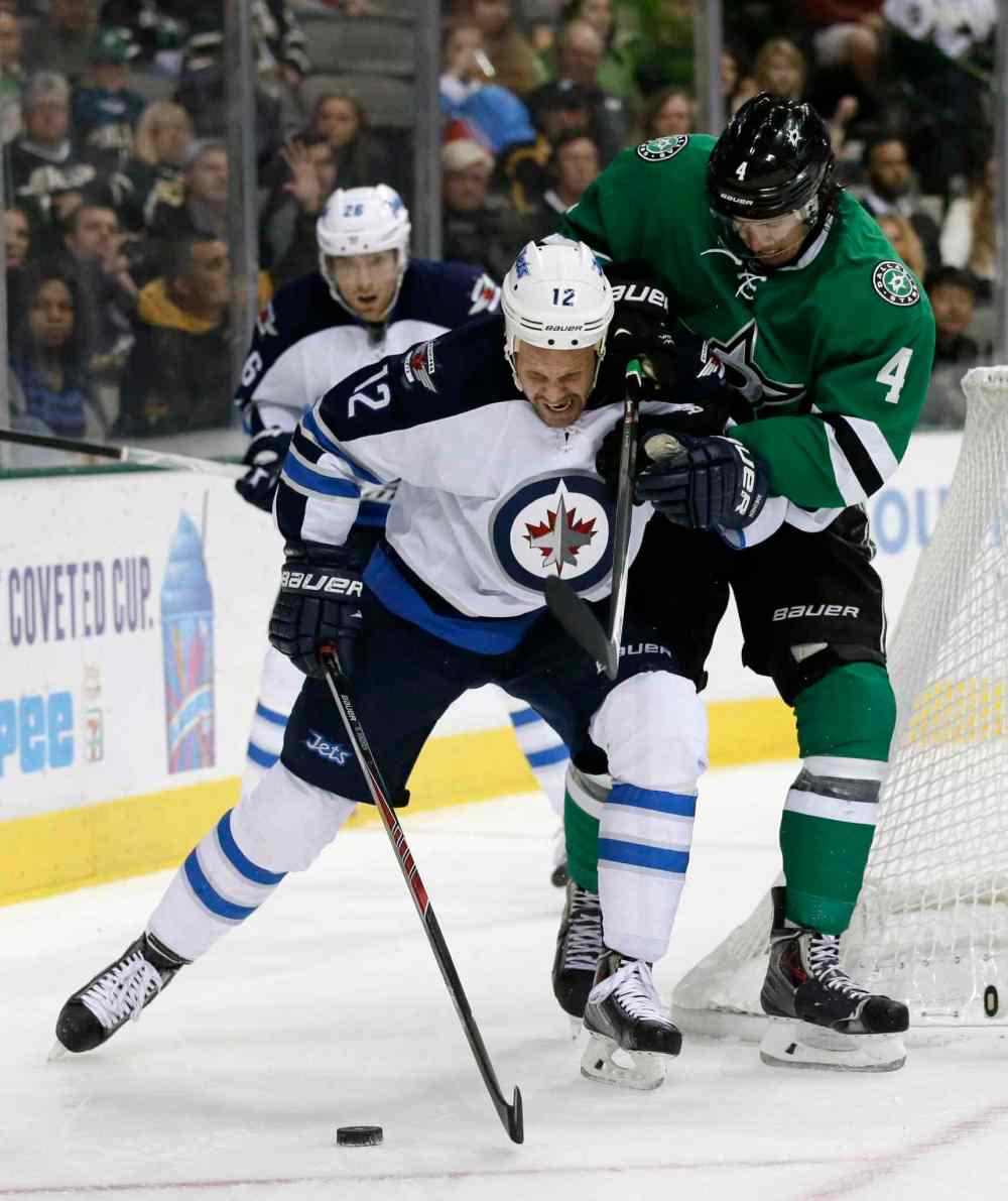 Tony Gutierrez / The Associated Press
Winnipeg Jets center Olli Jokinen fights off Dallas Stars defenceman Brenden Dillon during the second period.