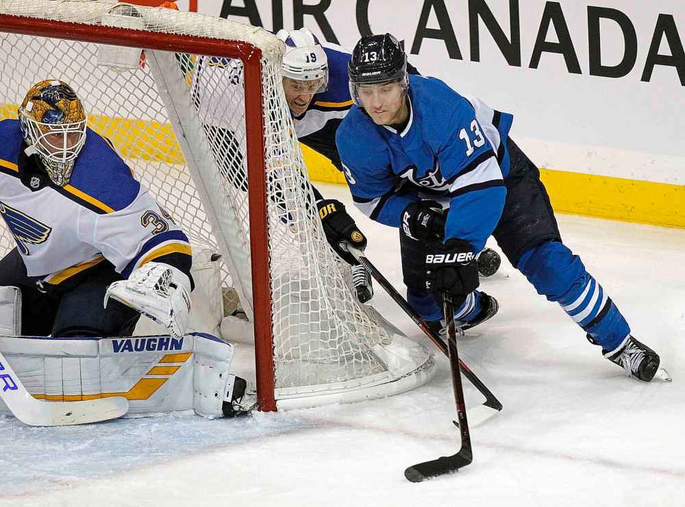 Phil Hossack / Winnipeg Free Press
Winnipeg Jets' Brandon Tanev wraps around St Louis Blues net minder Jake Allen Jay Bouwmeester in pursuit Friday night at Bell MTS Place.