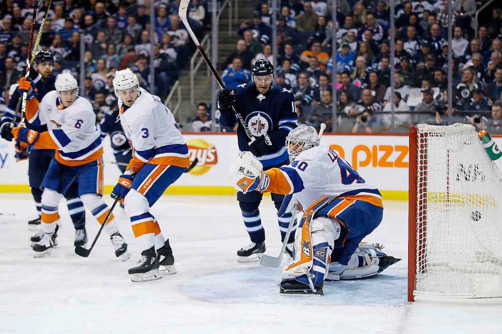 THE CANADIAN PRESS/John Woods
Winnipeg Jets' Bryan Little celebrates Brandon Tanev's goal on New York Islanders goaltender Robin Lehner as Adam Pelech defends during the second period.
