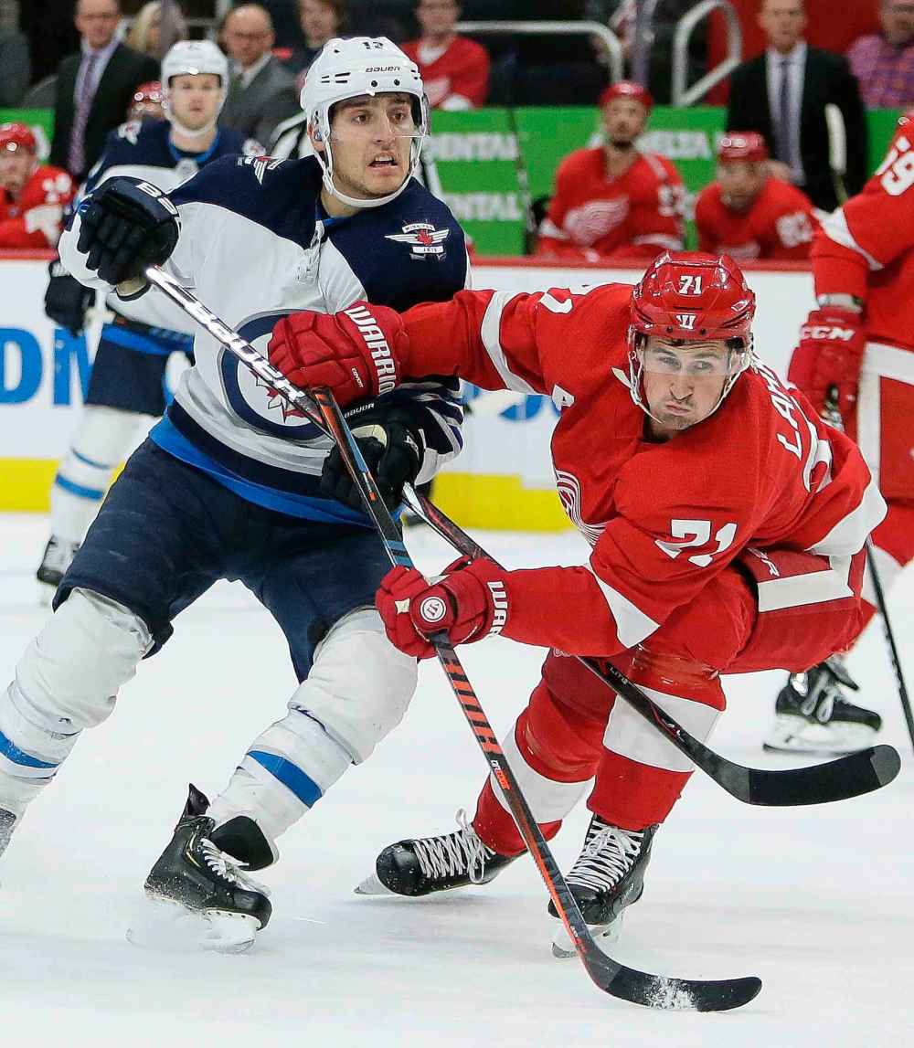 (AP Photo/Duane Burleson)
Winnipeg Jets left wing Brandon Tanev, left, battles for position with Detroit Red Wings center Dylan Larkin during the first period Friday.