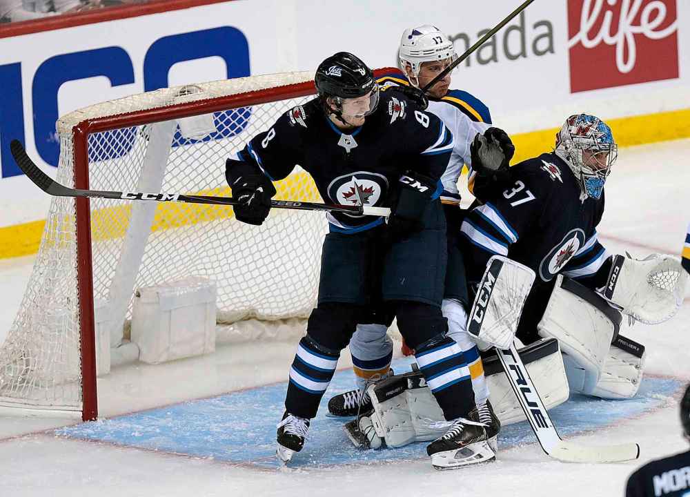 PHIL HOSSACK / WINNIPEG FREE PRESS
Winnipeg Jets' Jacob Trouba, left, fights off St Louis Blues' Jaden Schwartz in goalie Connor Hellebuyck's crease Wednesday.