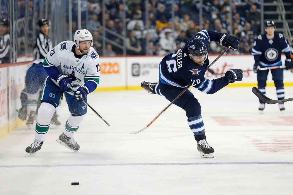 THE CANADIAN PRESS/John Woods
Winnipeg Jets' Blake Wheeler works his way around Vancouver Canucks' Alexander Edler during the second period.