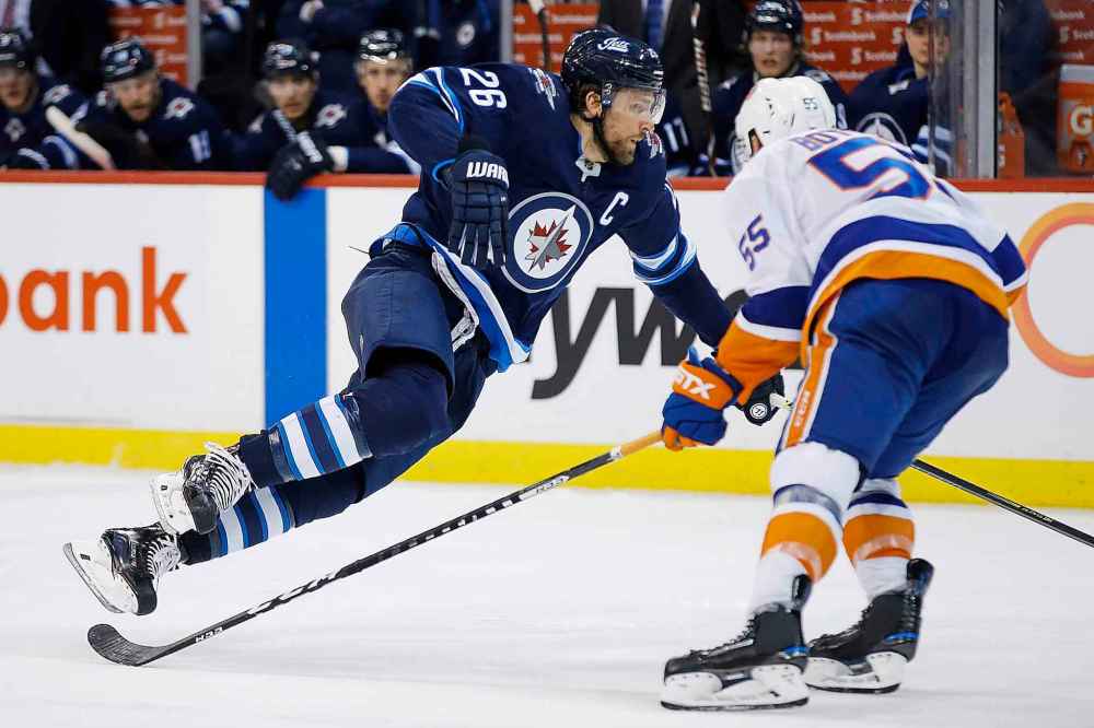THE CANADIAN PRESS/John Woods
Winnipeg Jets' Blake Wheeler is tripped by New York Islanders' Johnny Boychuk during the second period. Boychuk received a two-minute minor penalty on the play.
