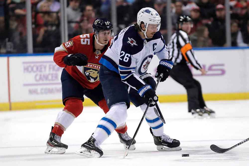 (AP Photo/Lynne Sladky)
Winnipeg Jets' Blake Wheeler looks to pass as Florida Panthers' Noel Acciari defends during the first period.