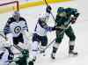 Ann Heisenfelt / The Associated Press
Minnesota Wild centre Charlie Coyle (right) tries to manouevre the puck past Winnipeg Jets defenceman Tobias Enstrom and goalie Ondrej Pavelec.