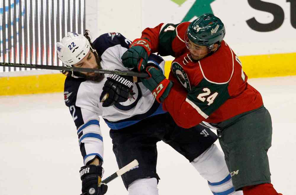 AP Photo / Ann Heisenfelt)
Minnesota Wild defenseman Matt Dumba (24) hits Winnipeg Jets right wing Chris Thorburn (22) during the first period.