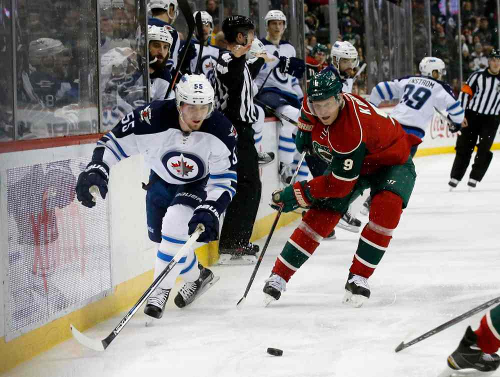 Ann Heisenfelt / The Associated Press
Minnesota Wild center Mikko Koivu (9), of Finland, and Winnipeg Jets center Mark Scheifele (55) chase the puck during the second period of an NHL hockey game in St. Paul, Minn., Friday, Nov. 27, 2015. The Jets won 3-1.