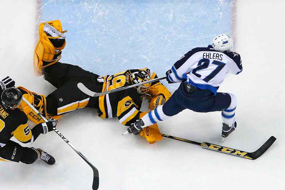 Gene J. Puskar / The Associated Press
Pittsburgh Penguins goalie Marc-Andre Fleury (29) makes a diving save on a break away by Winnipeg Jets left wing Nikolaj Ehlers (27) during the second period of an NHL hockey game in Pittsburgh, Saturday.