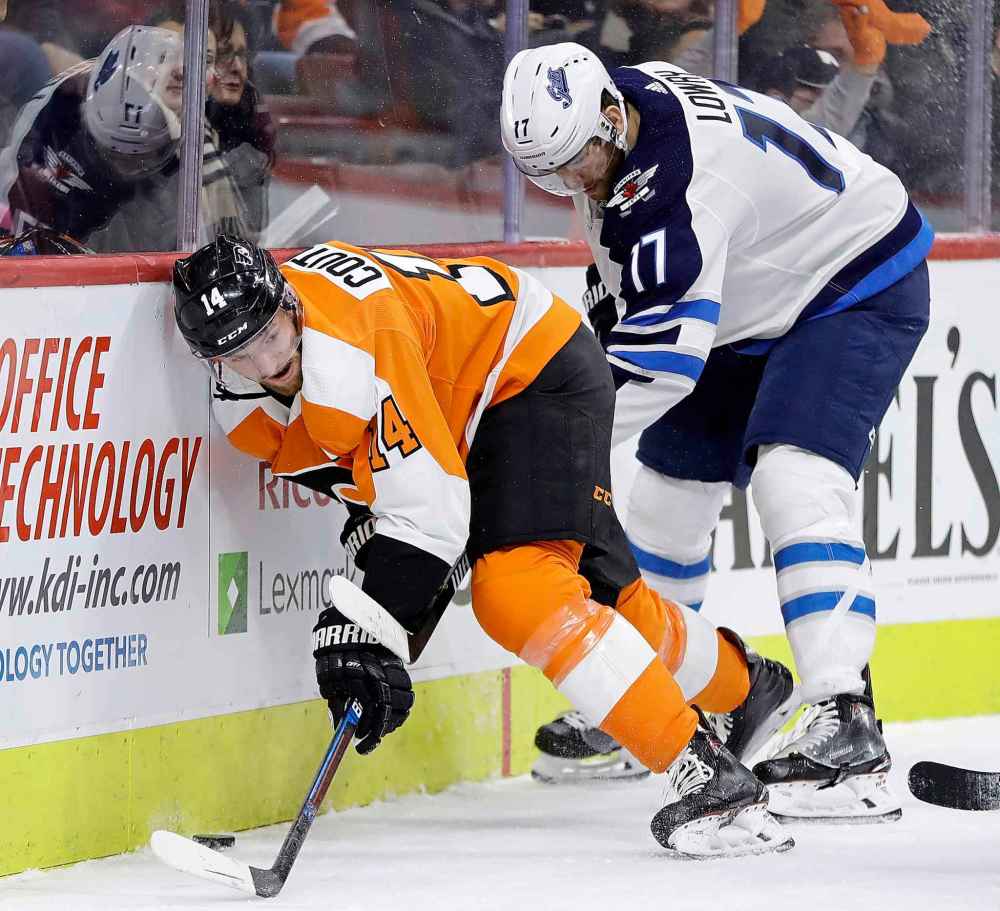 (AP Photo/Matt Slocum)
Philadelphia Flyers' Sean Couturier, left, tries to keep Winnipeg Jets' Adam Lowry away from the puck during the first period.
