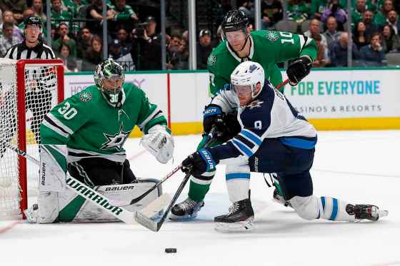 CPDallas Stars goaltender Ben Bishop gets help from right wing Corey Perry defending against a shot attempt by Winnipeg Jets' Andrew Copp in the second period in Dallas, Thursday.