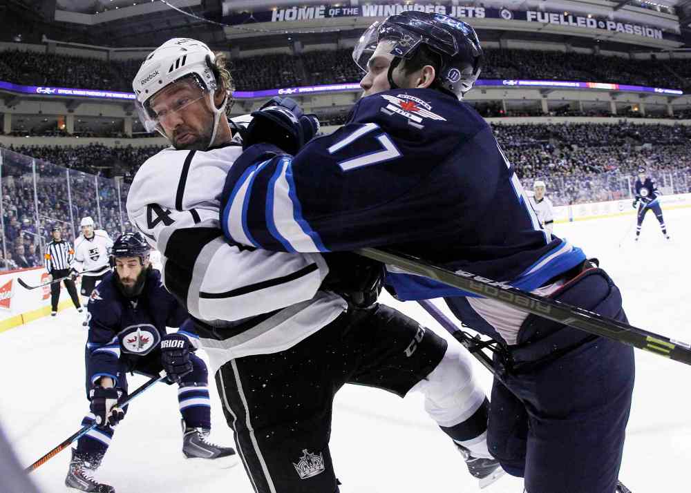 JOHN WOODS / WINNIPEG FREE PRESS
Winnipeg Jets forward Adam Lowry (17) checks Justin Williams of the Los Angeles Kings during second-period NHL action at the MTS Centre in Winnipeg Sunday.