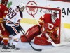 Edmonton Oilers' Sam Gagner, left, has his shot deflected by Calgary Flames goalie Mike Smith during first period NHL hockey action in Calgary, Saturday, April 6, 2019.THE CANADIAN PRESS/Jeff McIntosh
