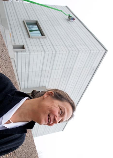 Architect Heike Hanada stands in front of the new Bauhaus Museum of the 'Klassik Stiftung Weimar' (Classic Foundation Weimar) in Weimar, Germany, Thursday, April 4, 2019. The museum designed by Berlin-based architect Heike Hanada will focus on the early Bauhaus that was founded in Weimar in 1919 and stayed there until 1925. The official opening of the new Bauhaus Museums will take place on Friday, April 5, 2019. (AP Photo/Jens Meyer)