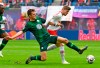 Wolfsburg's Robin Knoche, left, challenges for the ball against Leipzig's Timo Werner, right, during the German Bundesliga soccer match between RB Leipzig and VfL Wolfsburg in Leipzig, Germany, Saturday, April 13, 2019. (AP Photo/Jens Meyer)