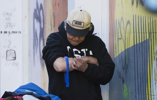 A man injects drugs in Vancouver's Downtown Eastside, Wednesday, Feb. 6, 2019. Despite significant efforts to combat overdose deaths in British Columbia, the provincial coroner says illicit drug overdose deaths increased to 1,489, just over the 2017 death total. THE CANADIAN PRESS/Jonathan Hayward