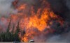 A giant fireball is seen as a wildfire rips through the forest 16 kilometres south of Fort McMurray, Alta. on Highway 63 Saturday, May 7, 2016. THE CANADIAN PRESS/Jonathan Hayward
