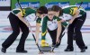 Northern Ontario skip Krista McCarville, centre, watches her shot as lead Sarah Potts and second Ashley Sippala sweep during the sixth draw against Alberta at the Scotties Tournament of Hearts, in Grande Prairie, Alta., on Monday, Feb. 22, 2016. THE CANADIAN PRESS/Jonathan Hayward