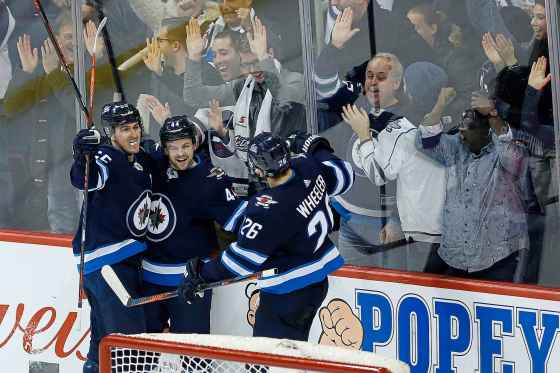 THE CANADIAN PRESS/John WoodsWinnipeg Jets' Mark Scheifele, Josh Morrissey and Blake Wheeler celebrate Morrissey's game-winning goal in overtime against the Edmonton Oilers in Winnipeg on Thursday.