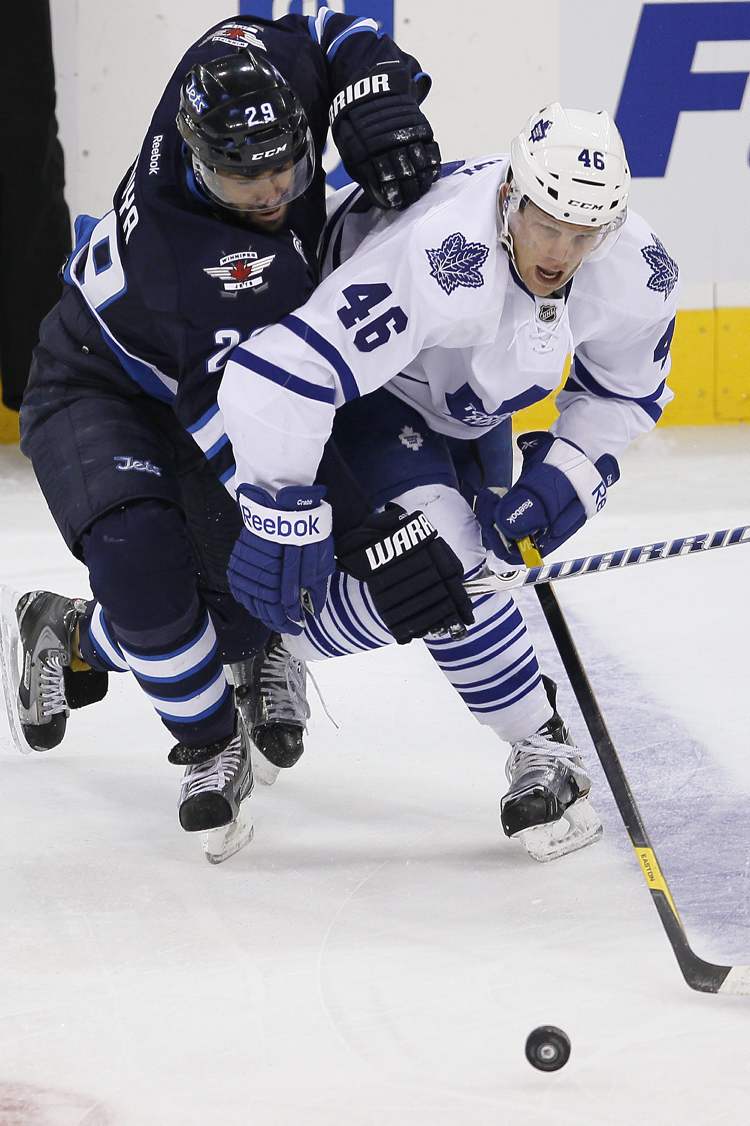 John Woods / Winnipeg Free Press
Winnipeg Jets' Johnny Oduya (29) and Toronto Maple Leafs' Joey Crabb (46) jostle for the puck during first-period action.