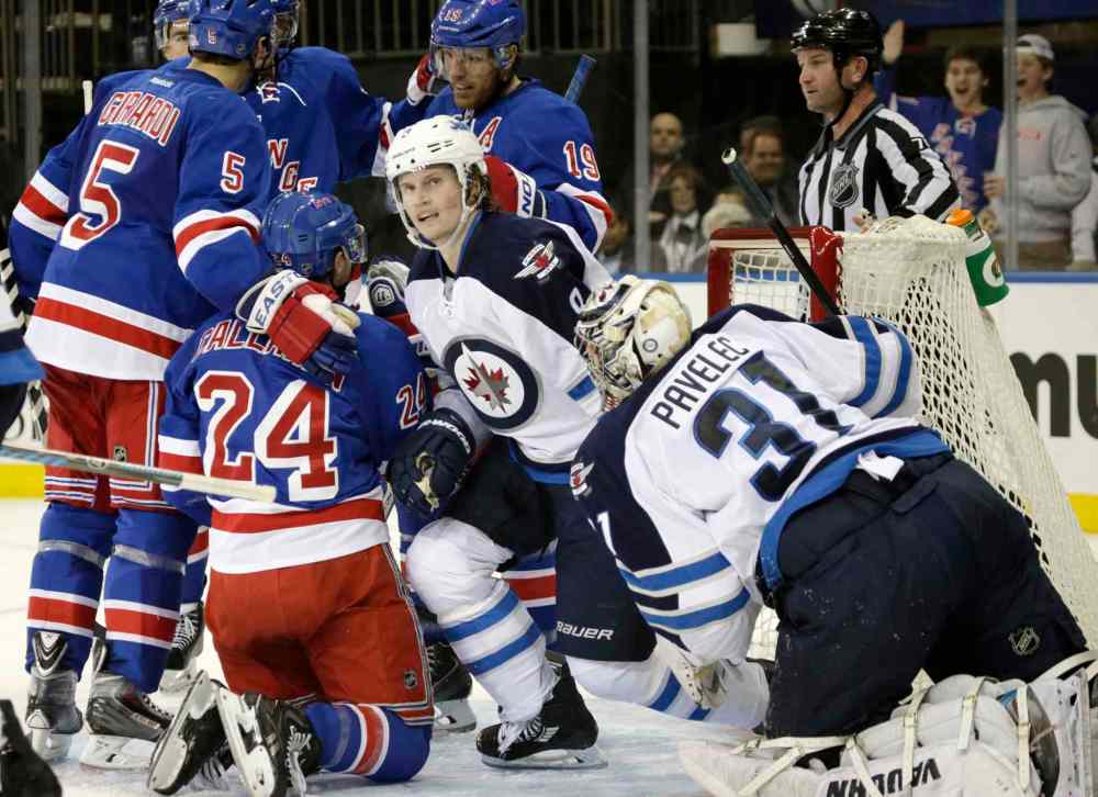 KATHY WILLENS / THE ASSOCIATED PRESS
New York Rangers' Dan Girardi (5) congratulates teammate Ryan Callahan (24) after Callahan scored on Winnipeg Jets goalie Ondrej Pavelec in the second period of an NHL game at Madison Square Garden in New York Monday. Jets defenceman Jacob Trouba (8) watches the replay onthe scoreboard.