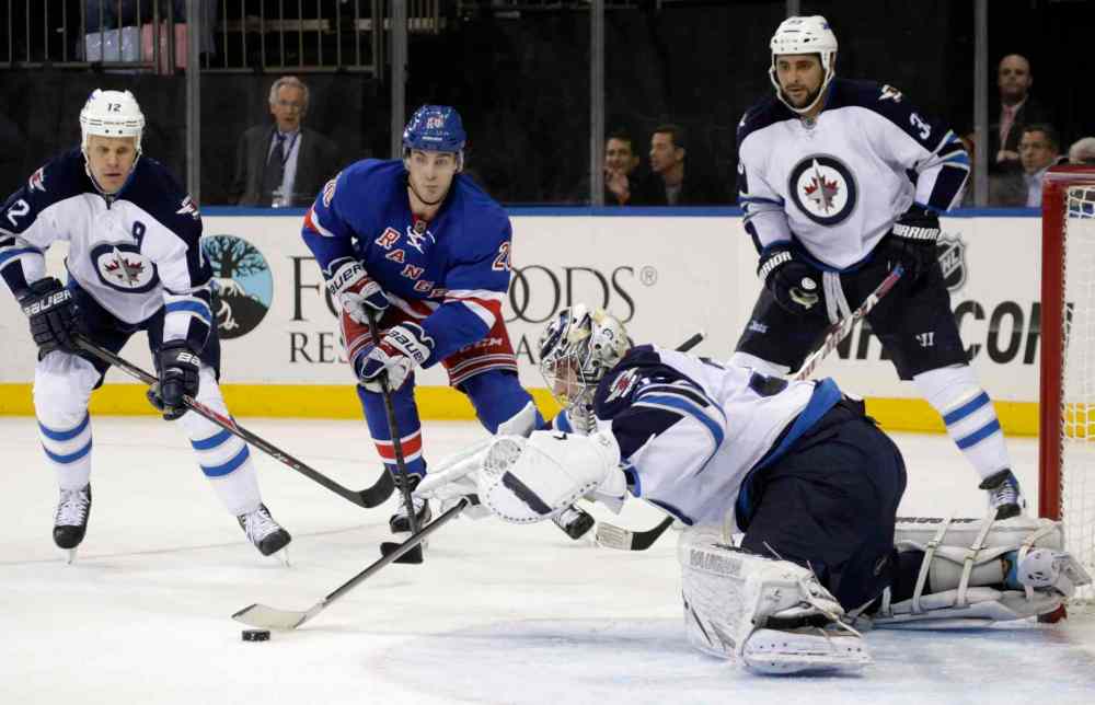 KATHY WILLENS / THE ASSOCIATED PRESS
Winnipeg Jets goalie Ondrej Pavelec makes a save as teammates Olli Jokinen (left) and Dustin Byfuglien defends against New York Rangers left-winger Chris Kreider during the second period.
