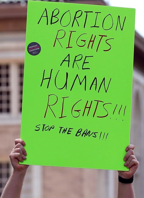Abortion rights advocates gather. Tuesday, May 21, 2019, at the Capitol in Jackson, Miss., as they rally to voice their opposition to state legislatures passing abortion bans. (AP Photo/Rogelio V. Solis)