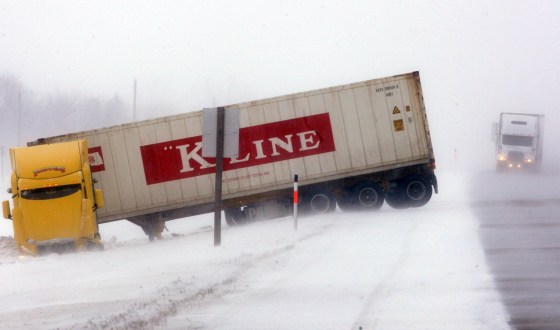 JOE BRYKSA / WINNIPEG FREE PRESSA semi, and several other motorists, lays jackknifed in the ditch between Portage La Prairie and Winnipeg this morning.