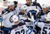 Blake Wheeler is congratulated by teammates after scoring in the shootout against the New Jersey Devils Friday Night in Newark. (Noah K. Murray / The Associated Press)