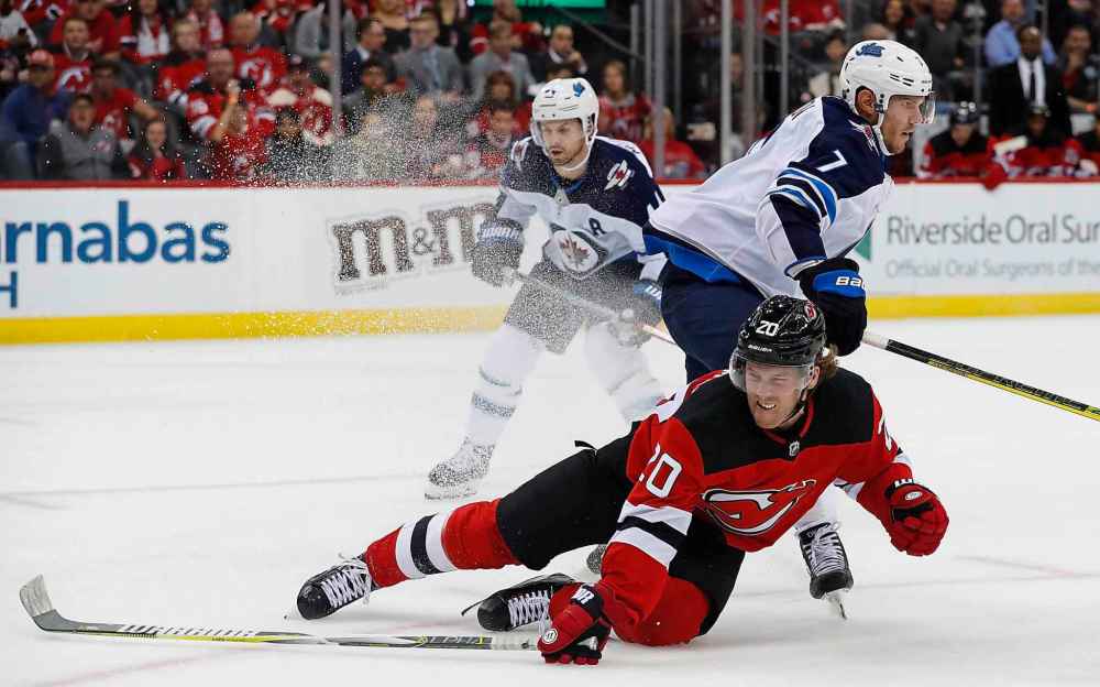 Coleman falls to the ice after scoring a goal during the second period. (Noah K. Murray / The Associated Press)