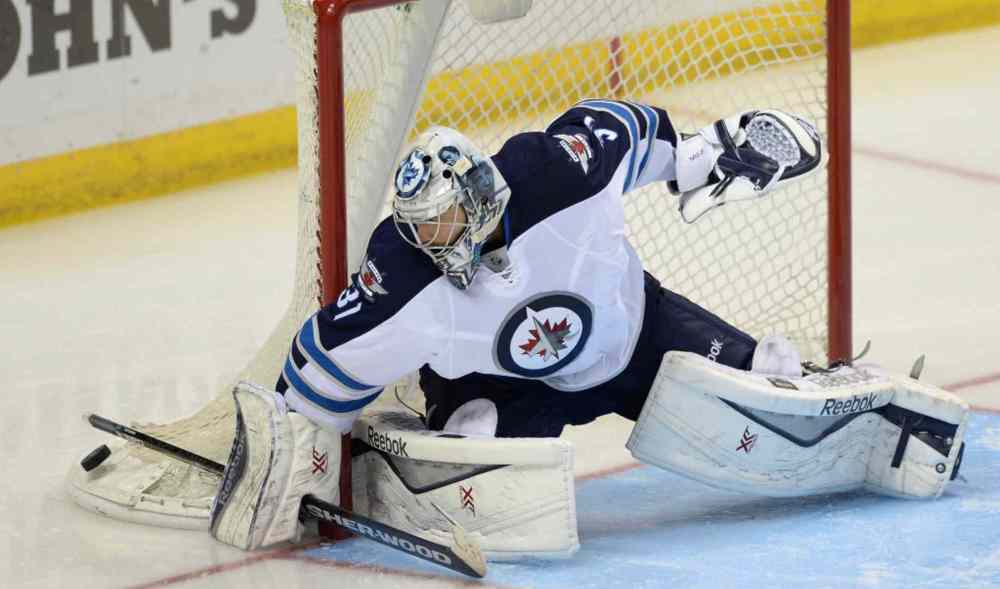 Bill Boyce / The Associated Press
Winnipeg Jets' goalie Ondrej Pavelec (31) blocks a shot against the St. Louis Blues during the third period of Tuesday's game.