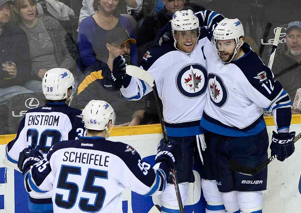 Mark Zaleski / The Associated Press Files
Winnipeg Jets right wing Blake Wheeler, center at right, celebrates with Drew Stafford (12), Tobias Enstrom, left, and Mark Scheifele (55).