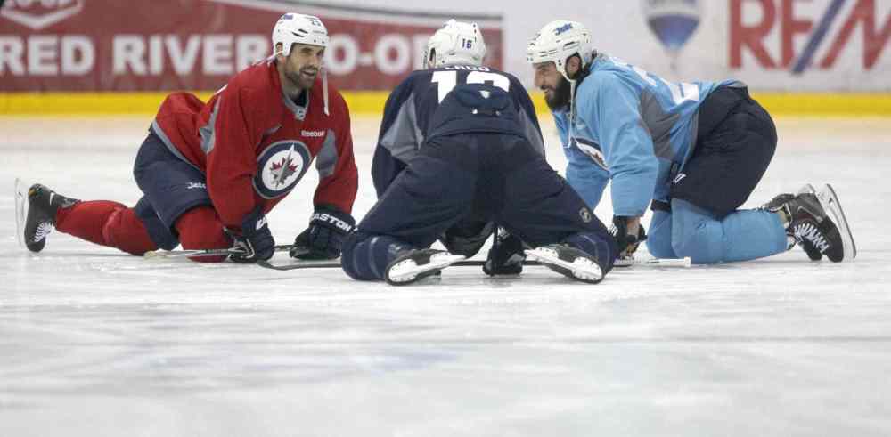 JOE BRYKSA / WINNIPEG FREE PRESS
Winnipeg Jets (from left) Jay Harrison, Andrew Ladd and Chris Thorburn have a chat on day one of on ice training camp Friday at the MTS Iceplex in Winnipeg.