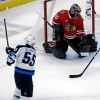 (AP Photo/Nam Y. Huh)
Winnipeg Jets centre Mark Scheifele scores the game-winning goal against Chicago Blackhawks goalie Corey Crawford during overtime Friday, in Chicago. The Jets won 4-3.