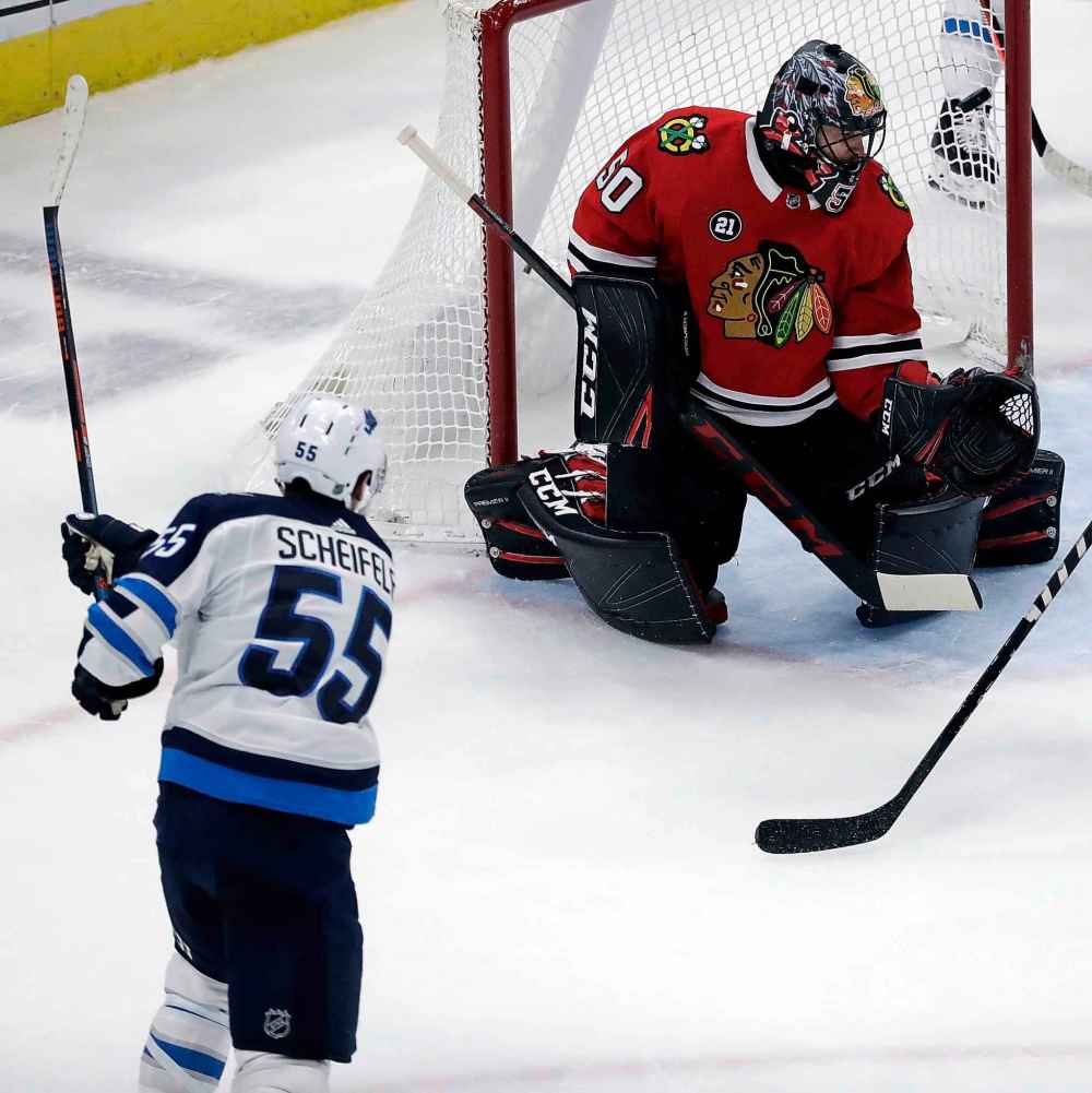 (AP Photo/Nam Y. Huh)
Winnipeg Jets centre Mark Scheifele scores the game-winning goal against Chicago Blackhawks goalie Corey Crawford during overtime Friday, in Chicago. The Jets won 4-3.